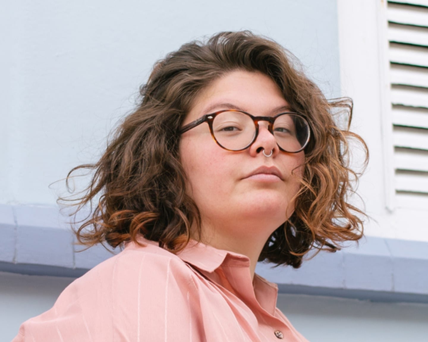 Woman with glasses and curly hair