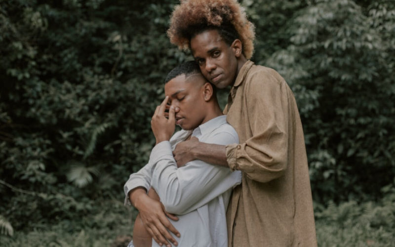 men embracing in dresses