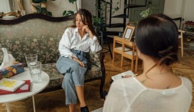 woman sitting on couch with therapist across