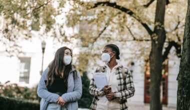 two students wearing masks walking together