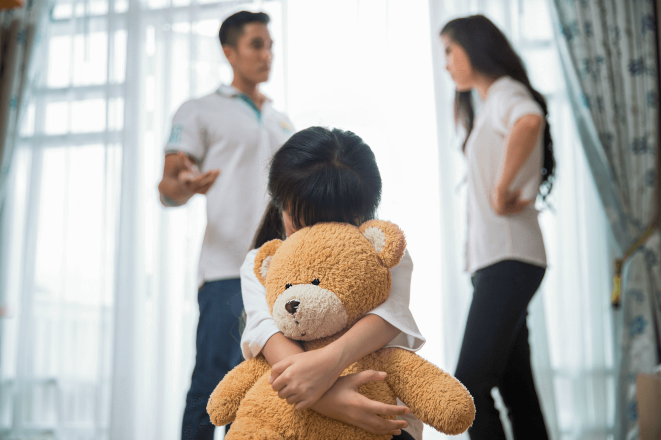 mother and father arguing sad daughter with teddy bear