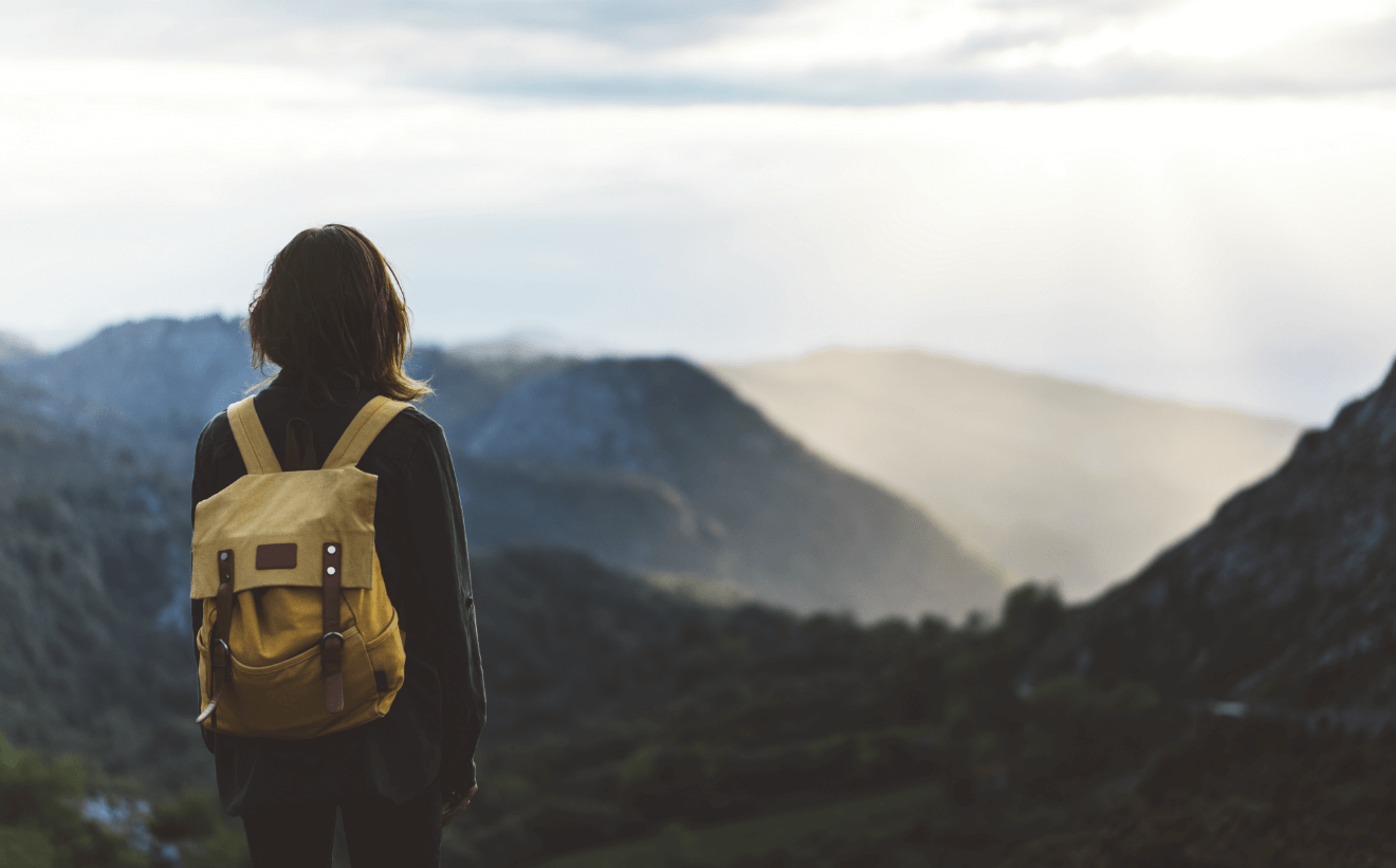 woman backpacking mountains